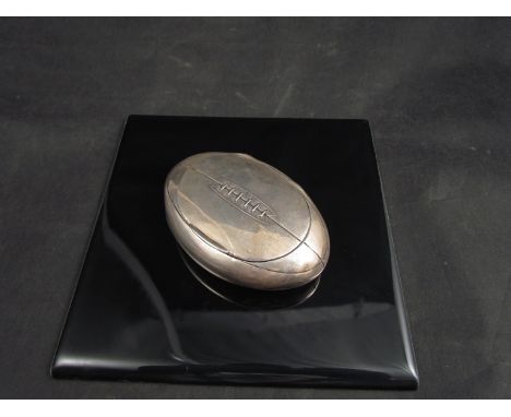 A Henry Williamson Ltd, snuff box of rugby ball form, dented, Birmingham 1905, 9cm long 