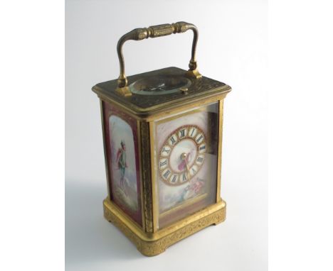 A 19th Century French brass carriage clock with highly engraved case and handle, Sevres style handpainted porcelain dial and 