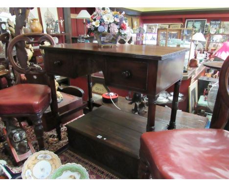 A George III flamed mahogany side/writing table the two frieze drawers and knee hole aperture over ring turned legs and stret
