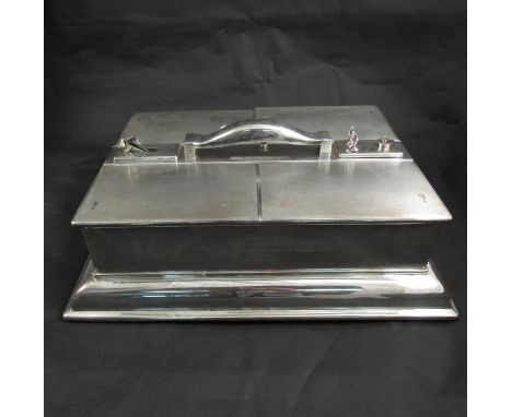 A silver humidor of large proportions with four lift top engine turned hinged compartments, the handle with integrated vesta 