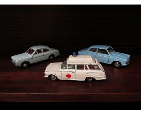 Three vintage Dinky cars comprising of a Ford Cortina, Ford Escort and a Vauxhall Ambulance with stretcher and patient