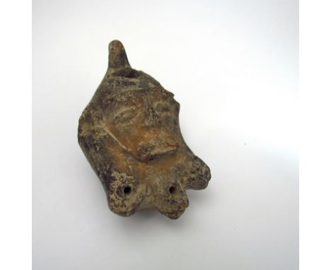 A terracotta oil lamp as a bearded face, possibly 2000 years old