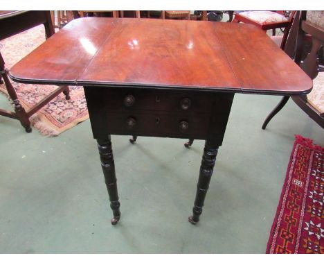 A circa 1840 flame mahogany drop leaf table the rising leaves over two end drawers and two faux drawers on ring turned taperi