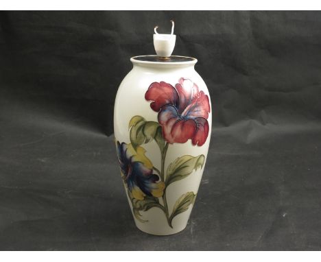 A Walter Moorcroft Hibiscus pattern lamp base with paper label potters to late Queen Mary, 26cm tall