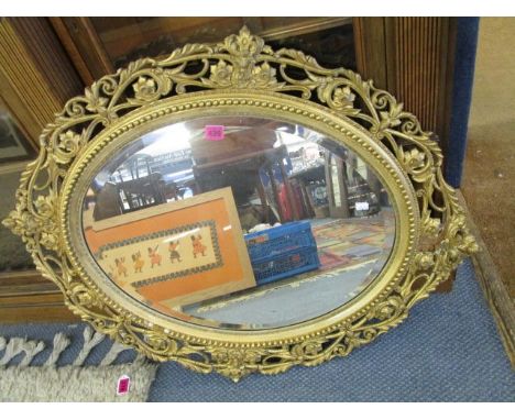 A gilt framed oval wall mirror with pierced, scrolled and floral surround, A/F, 36 long, a wood effect wall mirror with recta