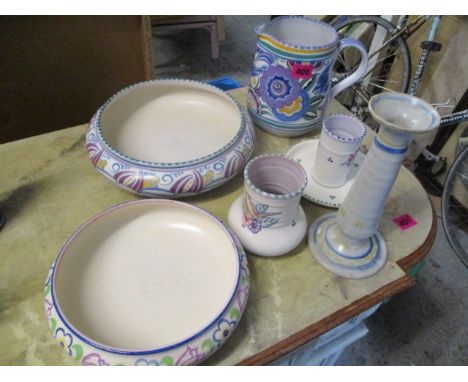 A mixed lot of early 20th century Poole pottery to include bowls, a jug, one plate, two vase and a candlestick