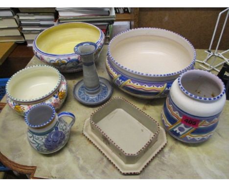 A mixed lot of early 20th century Poole pottery to include bowls, a jug, a vase and a candlestick