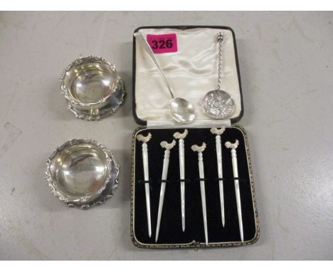 Silver and white metal to include a pair of salts, a teaspoon, a collectors spoon and a set of six cocktail sticks with mothe