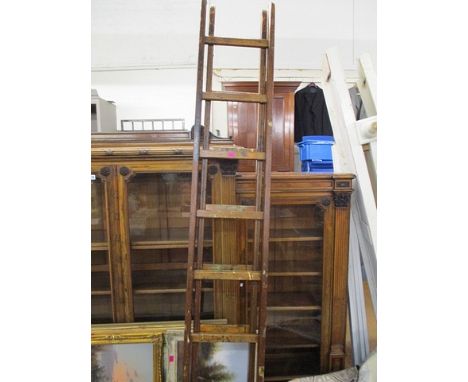 An early 20th century wooden, two section ladder, extending