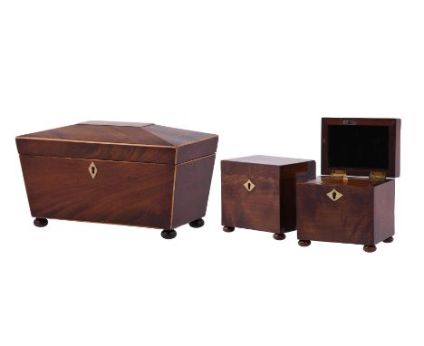 
	
		A pair of mahogany rectangular tea caddies, 19th century, with brass inlaid escutcheon and on bun 11cm high, 12cm wide, 