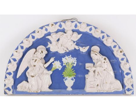 
	
		A glazed terracotta lunette depicting The Annunciation after Andrea Della Robbia, 19th century, modelled in white relief