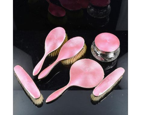 A George V Art Deco silver and pink enamel 6-piece dressing table set, comprising hand mirror, 2 x hair brushes, 2 x clothes 