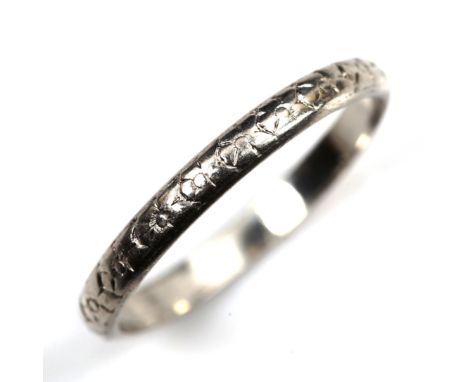 A platinum wedding band ring, engraved floral decoration, maker's marks S and W, band width 2.3mm, size P, 2.6gNo damage or r