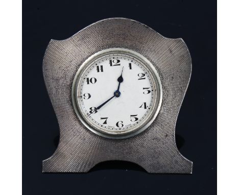 A George V Art Deco silver desk clock, engine turned decoration with silvered dial, Arabic numerals and blued steel hands, by