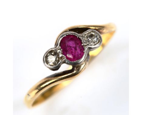 An 18ct gold three stone ruby and diamond crossover ring, set with oval mixed-cut ruby and old-cut diamonds, setting height 6