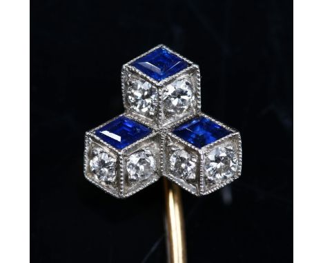 An Art Deco sapphire and diamond single "tumbling cube" stick pin, unmarked yellow and white metal settings, with geometric d