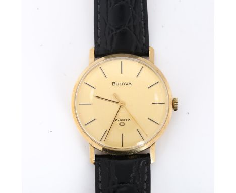 BULOVA - a Vintage 9ct gold quartz wristwatch, champagne dial with baton hour markers and sweep centre seconds hand, calibre 