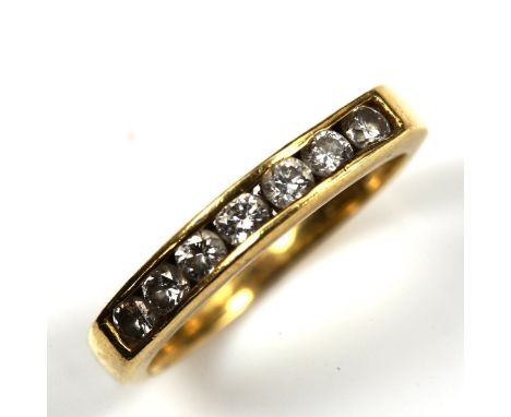 A modern 18ct gold seven stone diamond half eternity ring, channel set with modern round brilliant-cut diamonds, total diamon