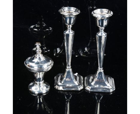 A pair of silver table candlesticks, and silver dressing table atomiser, candlestick height 18cm (2)All are quite heavily den