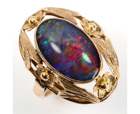 A large Continental black opal doublet dress ring, unmarked gold settings with floral bezel, setting height 24.4mm, size P, 5