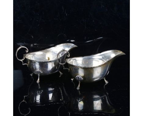 A pair of George V silver sauce boats, with scalloped rims and C-shaped handles, maker's marks TS, hallmarks Birmingham 1933,