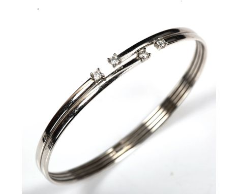 A modern Italian 9ct white gold cubic zirconia torque bangle, band width 5.5mm, internal measurement 6cm x 5cm, 5.5gNo damage