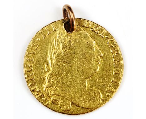 A George III 1775 gold guinea coin, fourth portrait with rose shield and pierced pendant loop, 8.3g 