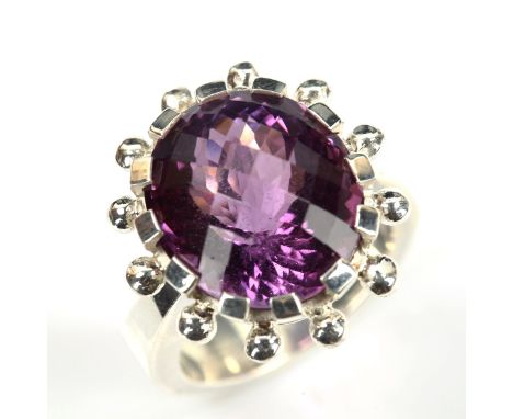 A modern heavy sterling silver amethyst dress ring, bead surround set with rose-cut amethyst, setting height 22.5mm, size O, 