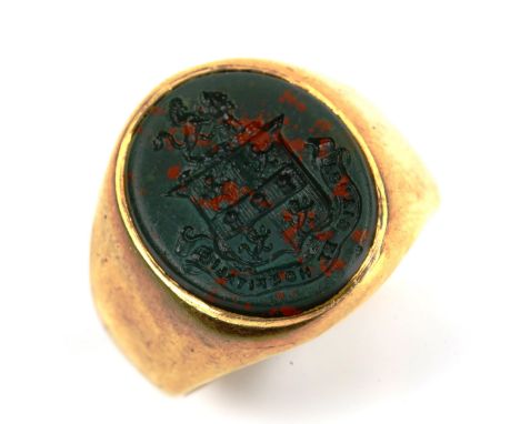 An Antique armorial bloodstone seal signet ring, unmarked gold settings with intaglio carved seal, rampant lion emblem and mo