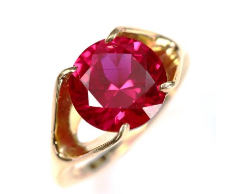 A late 20th century synthetic ruby dress ring, unmarked gold settings with round-cut synthetic ruby, ruby diameter 10.08mm, s