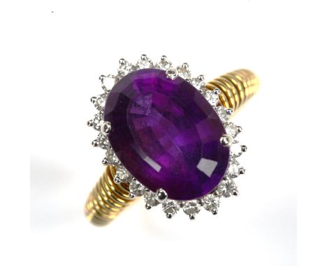 A late 20th century amethyst and diamond cluster dress ring, unmarked gold settings with oval mixed-cut amethyst and modern r