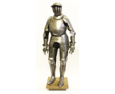 A full size replica suit of armour with round plain helmet with six vertical grills to visor, sectional constructed pauldrons