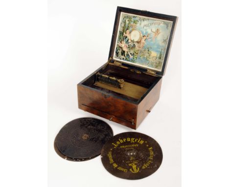 An 19th Century German oak cased Polyphon music box with singular comb movement with illustrated lid interior, front of body 