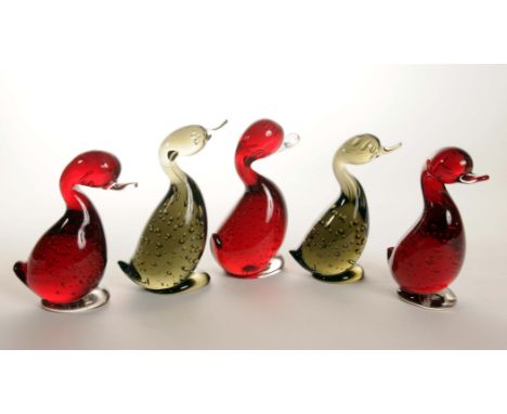 A group of five 20th Century Whitefriars glass ducks, two in smokey grey colour and the others in ruby red colour, one retain