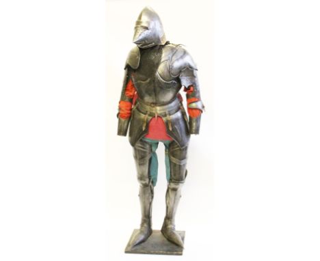 A full size replica suit of armour with cone shaped helmet and pointed visor, sectional constructed pauldrons and plackart, b