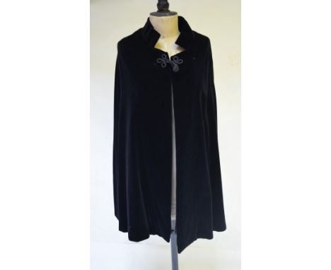 A black velvet evening cloak with cord fastening, to/w a 'Qoomi' full-length black velvet evening coat profusely covered in g