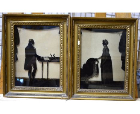 A companion pair of Regency silhouette reverse painting on glass studies of a gentleman at his desk holding a letter, and a l