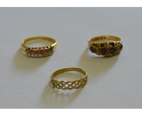 A ruby and diamond ring set with seven rose diamonds and seven small rubies in two rows, yellow metal claw set to/w Victorian