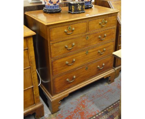 An 18th century chequerbanded and cross-banded mahogany chest of two short over three long cockbeaded drawers with original b