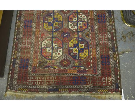 An antique Belouch long rug, the multi-coloured geometric design on red/brown ground, 2.34 x 1.10 m Condition Report Good ove