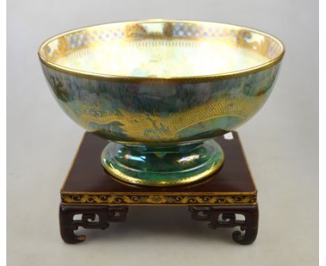 A large Wedgwood lustre footed bowl deigned by Daisy Makeig-Jones, the exterior decorated with dragons chasing a flaming pear
