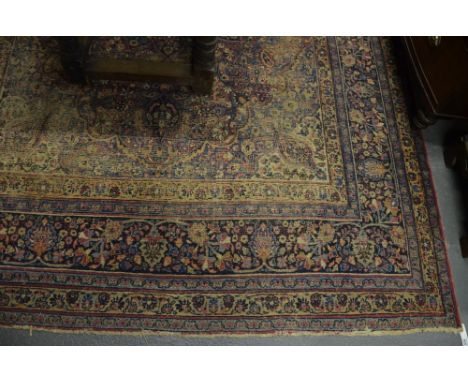 An antique Persian Meshed carpet, the field centred by a floral medallion, 338 x 240 cm Condition Report Low pile overall, fo