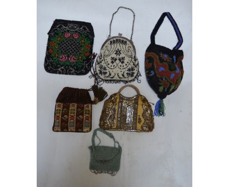 A collection of six early 1900's heavily beaded and sequinned evening bags, including a wool tapestry and silk example