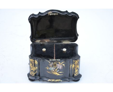 A Victorian mother-of-pearl inlaid gilt decorated papier mache tea caddy, of waisted form raised on turned feet
