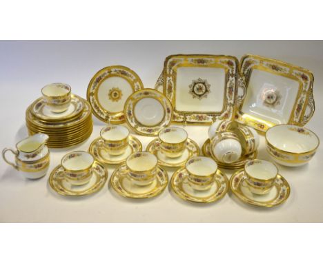 A Wedgwood gilded tea service with enamelled floral scrolls, patt W192/12 comprising 9 teacups, 12 saucers, 12 plates, sugar 