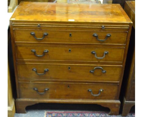 A 19th century inlaid mahogany chest of four long drawers beneath a full width slide, raised on shaped bracket feet, 83 cm hi