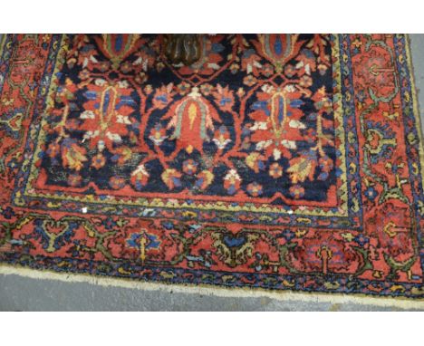 An old Persian Baktiari rug, 3rd quarter 20th century, the tulip design on blue ground Condition Report old moth damage to ar