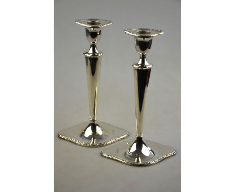 An Edwardian pair of loaded silver candlesticks of shaped oval form, 22.5 cm high, London 1905 Condition Report The base to e