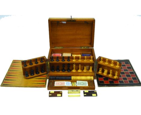 A Victorian mahogany cased games compendium containing a set of turned boxwood chessmen (King 6.5 cm high), draughts, boards 