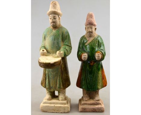 Chinese 10th century AD - Two pottery funerary figures, the larger playing a musical instrument, both with green and brown gl
